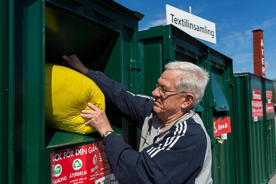 Bild: Man som lämnar textilier på återvinningscentral.